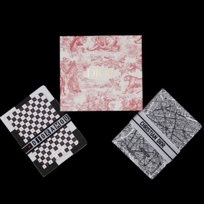 three cards with different designs on them on a black background