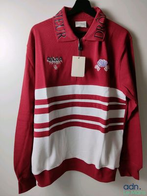a red and white striped sweatshirt with a tag on it