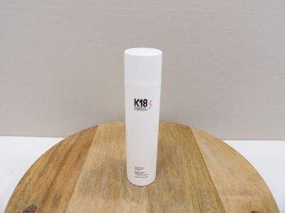 a white bottle sitting on top of a wooden table