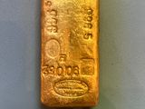 a gold bar sitting on top of a white surface