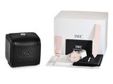 the watch is next to a black case and a white box