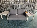 a couch and a table in a room with a glass wall behind it