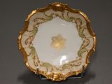 an image of a gold and white plate on a stand