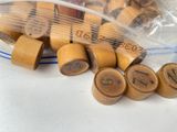 a bag full of wooden dice pieces with numbers on them