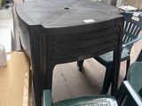 a table and chairs in a room with a lot of boxes