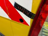 a tape on the side of a bus with a red and white stripe