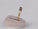 a gold ring with a blue stone on top of it