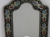 a close up of a mirror on a wall with a tag on it