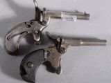 two revolvers that are sitting next to each other on a table
