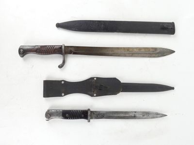 several different types of knives are lined up on a white surface
