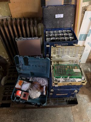many different types of tools sitting on a pallet next to a radiator