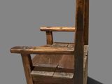 a wooden chair that is sitting on a table