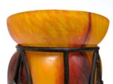 a close up of a glass vase with a drum on it