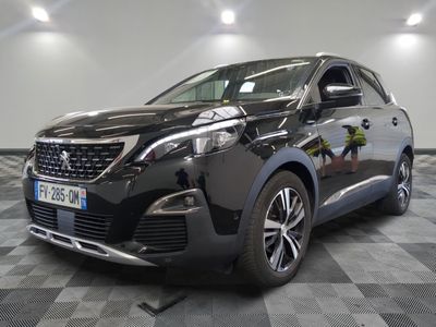 la voiture noire est garée sur un sol en damier dans le garage