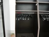 a black and white closet with two shelves and a freezer