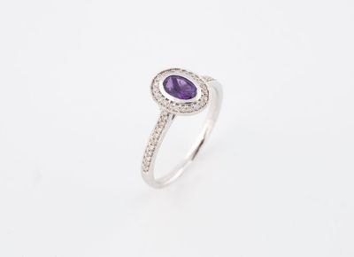 une bague en or blanc sertie d'une améthoralite ovale et d'un diamant
