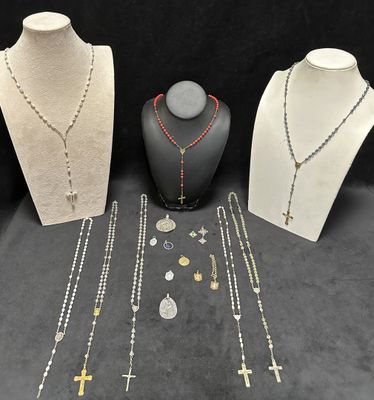 three necklaces, a necklace, and a necklace with a cross on it