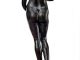 statue of a woman standing on top of a marble pedestal
