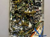 a box with a bunch of toy airplanes and a pair of scissors