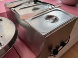 two pans and a bowl on the counter in the kitchen