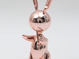 a metal rabbit figurine on a white background