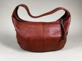 an image of a brown leather purse with a zipper on it