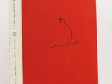 a red book with a drawing of a bird on it
