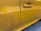 a close up of a yellow car door handle