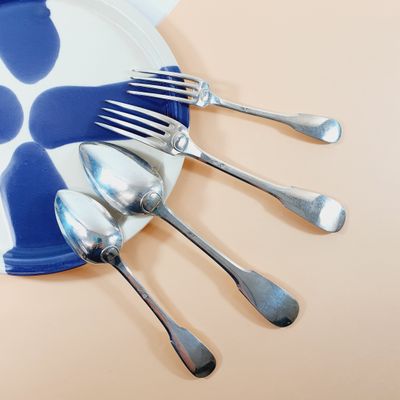 a plate with a bunch of forks and spoons on it
