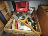 a wooden box filled with assorted items on a table