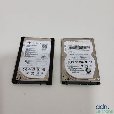 two hard drives are sitting side by side on a table