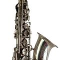 a silver saxophone that is sitting on a white surface