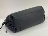 the large black bag is sitting on a white surface