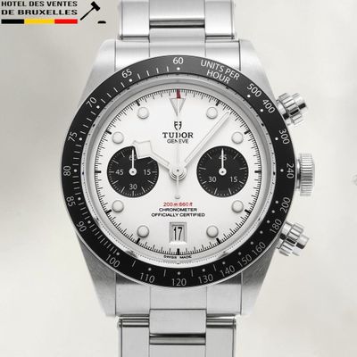 a silver watch with a black face and a white dial