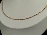 a close up of a gold chain on a mannequin