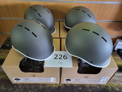three helmets are sitting on top of a cardboard box on a table