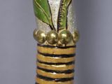 a close up of a vase with a flower on it