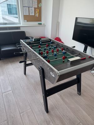 a foosball table in the corner of a living room