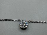 a close up of a diamond on a chain on a table