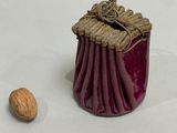 a small container that has a nut in it