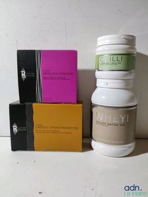 two bottles of whey next to a box of vitamins