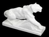 a white statue of a lion on a black background