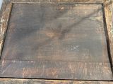 an old wooden box with a hole in the middle of it