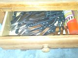 a drawer full of knives and other kitchen utensils