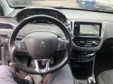 a man sitting in the driver ' s seat of a car