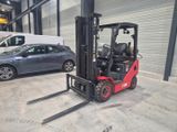 a forklift in a warehouse with a car in the background