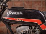a close up of a motorcycle parked in front of a brick wall