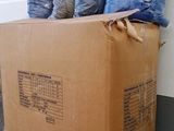 a cardboard box that has a bunch of bags on top of it