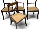 quatre chaises avec une assise marron et un coussin marron posé dessus