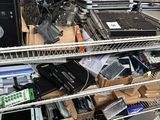a lot of electronic equipment on the shelves in the room